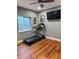 Home workout room with wood floors, ceiling fan, treadmill and mounted television at 5893 Lasso Pl, Parker, CO 80134