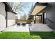 A modern backyard patio features an outdoor living space with comfortable seating at 1462 S Vine St, Denver, CO 80210