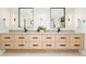 A modern bathroom features a double vanity with sleek cabinetry, contemporary mirrors, and stylish lighting fixtures at 1462 S Vine St, Denver, CO 80210
