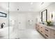 Bright bathroom featuring a soaking tub, glass shower, double vanity, and marble tile flooring at 1462 S Vine St, Denver, CO 80210