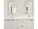 Bathroom featuring double sinks, modern hardware, and stylish white cabinets at 1462 S Vine St, Denver, CO 80210