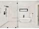 Spa-like bathroom featuring freestanding tub, walk-in shower, and sleek modern design at 1462 S Vine St, Denver, CO 80210