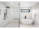 Sleek bathroom featuring a soaking tub and glass shower with marble tile surround at 1462 S Vine St, Denver, CO 80210