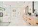A bright bathroom features modern fixtures, double vanities, a soaking tub, and a glass-enclosed shower at 1462 S Vine St, Denver, CO 80210