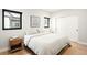 Bright bedroom features hardwood floors, modern windows, white walls, and minimal decor at 1462 S Vine St, Denver, CO 80210