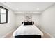 Comfortable bedroom with white linens, art and stylish lighting at 1462 S Vine St, Denver, CO 80210