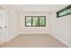 Bedroom with neutral-toned carpet, a large window, and neutral walls for a clean and serene space at 1462 S Vine St, Denver, CO 80210