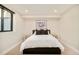 Modern bedroom featuring neutral tones, a comfortable bed, and minimalist decor for a relaxing ambiance at 1462 S Vine St, Denver, CO 80210