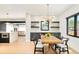 Bright dining room with modern chandelier, black accents, a dining table with black chairs at 1462 S Vine St, Denver, CO 80210