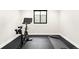 Bright exercise room featuring a stationary bike, yoga mat, and rubber floor at 1462 S Vine St, Denver, CO 80210