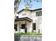 Beautiful two-story home featuring a well-manicured lawn and a striking facade with black framed windows at 1462 S Vine St, Denver, CO 80210