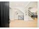 Bright foyer with light hardwood floors, modern staircase, and a clear view of the home's stylish interior at 1462 S Vine St, Denver, CO 80210
