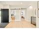 Inviting foyer with hardwood floors and glass sliding door leading to a study, offering a glimpse of the home's design at 1462 S Vine St, Denver, CO 80210