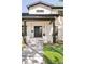 Contemporary home featuring a stylish black front door, modern lighting, and well-maintained landscaping at 1462 S Vine St, Denver, CO 80210