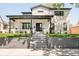 Striking modern home with a white brick facade, black trim, and meticulously landscaped front yard at 1462 S Vine St, Denver, CO 80210