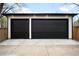 Spacious detached garage with black doors and modern lighting at 1462 S Vine St, Denver, CO 80210
