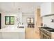 Bright, open kitchen featuring a white marble island, modern appliances, and an adjacent dining area at 1462 S Vine St, Denver, CO 80210