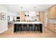 Spacious kitchen with large island, white countertops, black stools, and modern lighting fixtures above the island at 1462 S Vine St, Denver, CO 80210