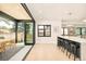 Spacious kitchen features stainless steel appliances, a marble island, barstools, and folding glass doors at 1462 S Vine St, Denver, CO 80210