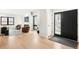 Spacious living room featuring a fireplace, large windows, and hardwood flooring at 1462 S Vine St, Denver, CO 80210