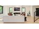 Modern living room featuring a sleek fireplace, hardwood floors, and ample natural light from large windows at 1462 S Vine St, Denver, CO 80210