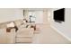 Cozy living room with comfortable seating, a mounted TV, and a door leading to a dedicated exercise area at 1462 S Vine St, Denver, CO 80210