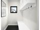 Bright mud room with bench, coat hooks and contrasting floor at 1462 S Vine St, Denver, CO 80210