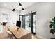 Office area featuring a custom wood desk, open black-framed doors and a hardwood floor at 1462 S Vine St, Denver, CO 80210