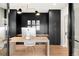 Office space featuring custom wood desk, modern lighting, and stylish storage with a contrasting color scheme at 1462 S Vine St, Denver, CO 80210