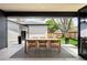 Covered patio features an outdoor dining table with seating for six overlooking the manicured backyard at 1462 S Vine St, Denver, CO 80210