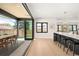 Open concept floor plan with kitchen island, black countertops, view of a covered patio with outdoor dining table at 1462 S Vine St, Denver, CO 80210