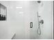Modern shower with sleek tile, a built-in bench, and a handheld shower head at 1462 S Vine St, Denver, CO 80210