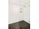 Sleek shower design with floor-to-ceiling subway tile and hexagonal tile flooring creating a modern, clean space at 1462 S Vine St, Denver, CO 80210