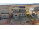 Aerial view of backyard including neighboring houses and dry landscape in the background at 15325 W 93Rd Ave, Arvada, CO 80007