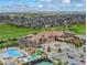 Aerial view of a luxurious community clubhouse, featuring a pool, waterslides, and meticulous landscaping at 7963 S Valleyhead Way, Aurora, CO 80016