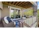 Inviting back deck with comfortable seating, a patterned rug, and views of the surrounding landscape at 7963 S Valleyhead Way, Aurora, CO 80016