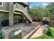 Stone back patio with stairs to balcony, and a hot tub, perfect for outdoor relaxation and entertaining at 7963 S Valleyhead Way, Aurora, CO 80016