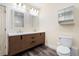 Modern bathroom with a double vanity, wood cabinets, and stylish fixtures at 7963 S Valleyhead Way, Aurora, CO 80016