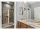 Bathroom with a granite countertop, stone shower, and vanity mirror at 7963 S Valleyhead Way, Aurora, CO 80016