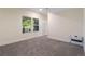 Bright bedroom with neutral walls, carpet flooring, and large windows overlooking the backyard at 7963 S Valleyhead Way, Aurora, CO 80016