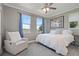 Bedroom featuring large windows with curtains, a ceiling fan and gray walls at 7963 S Valleyhead Way, Aurora, CO 80016