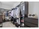 Modern walk-in closet with dark metal racks and glass storage cabinets for clothes and shoes at 7963 S Valleyhead Way, Aurora, CO 80016