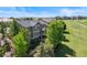 Beautiful home surrounded by mature trees, with a view of a nearby golf course and neighborhood at 7963 S Valleyhead Way, Aurora, CO 80016