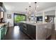 Open concept kitchen with a large island, stainless steel appliances and a door leading to the outside balcony at 7963 S Valleyhead Way, Aurora, CO 80016