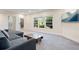 Bright living area with a comfortable sofa, rustic coffee table, and large windows overlooking the yard at 7963 S Valleyhead Way, Aurora, CO 80016