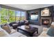 Comfortable living room featuring a stone fireplace, large windows, and a cozy seating area at 7963 S Valleyhead Way, Aurora, CO 80016