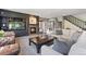Bright living room showcases a stone fireplace, TV, and a comfortable seating arrangement at 7963 S Valleyhead Way, Aurora, CO 80016
