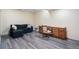 Cozy living space with a sofa, desk, and wood-look floors, perfect for relaxation and productivity at 7963 S Valleyhead Way, Aurora, CO 80016