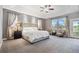 Spacious main bedroom featuring tray ceilings, carpet floors, natural lighting, and a ceiling fan at 7963 S Valleyhead Way, Aurora, CO 80016