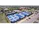 Aerial view of a community with multiple tennis courts adjacent to the clubhouse and pool area at 7963 S Valleyhead Way, Aurora, CO 80016